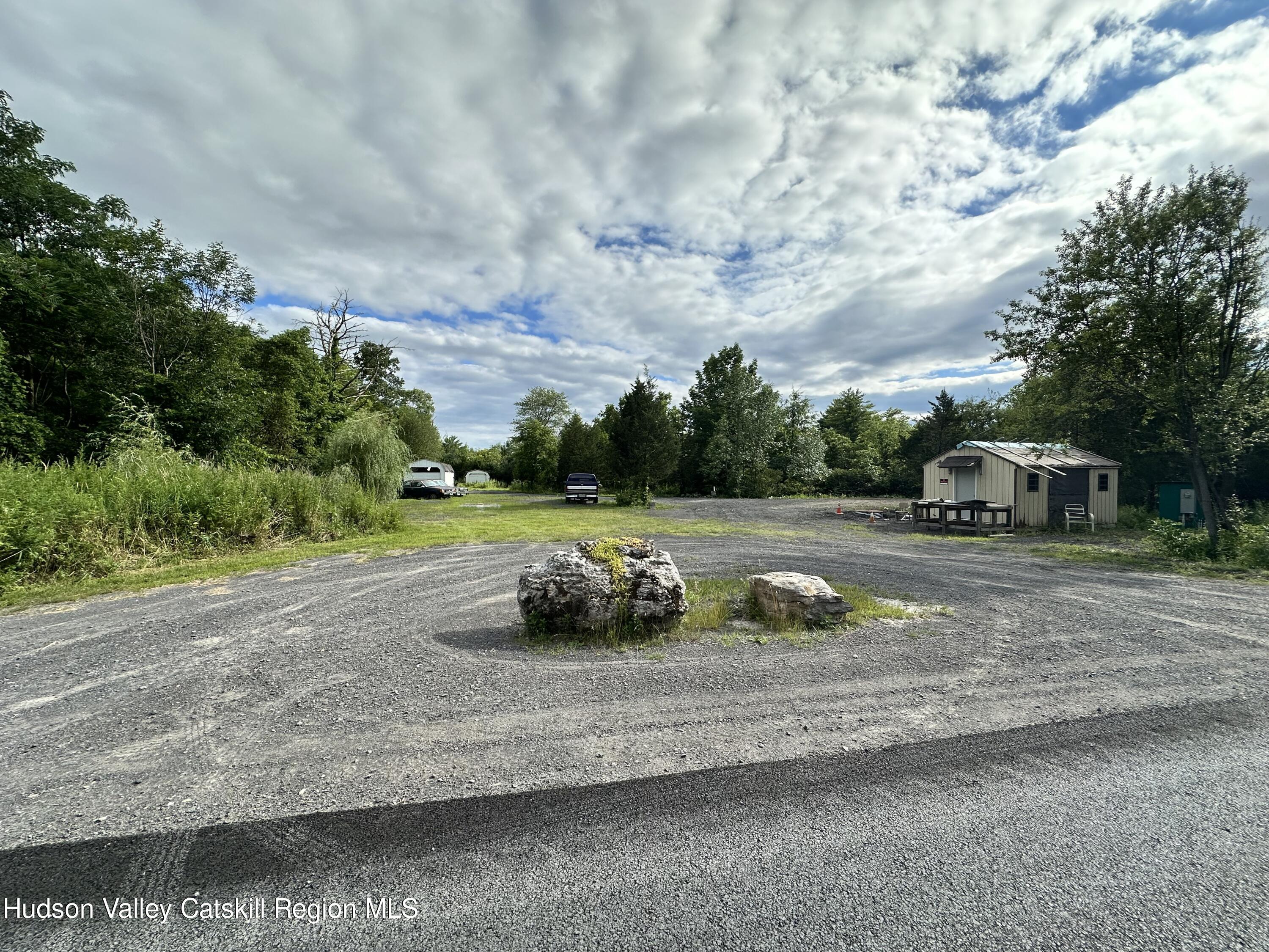 a view of a street with a cars parked