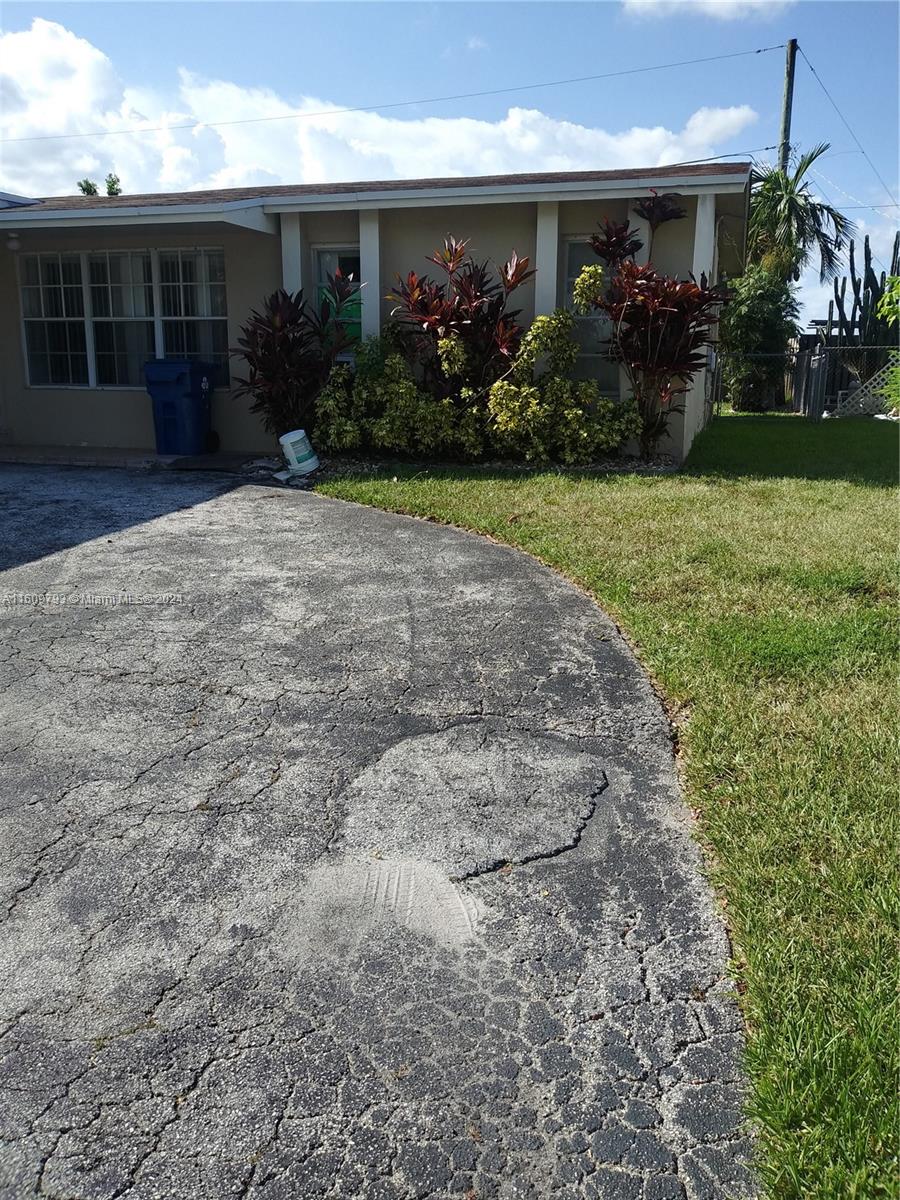 a front view of house and yard with green space