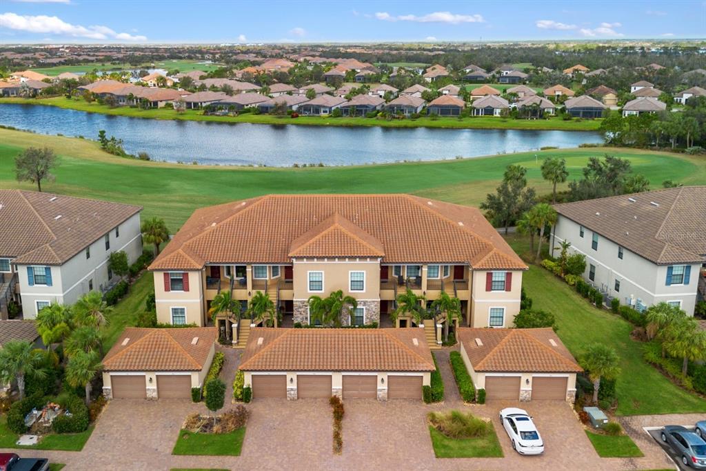 an aerial view of house with yard and lake view