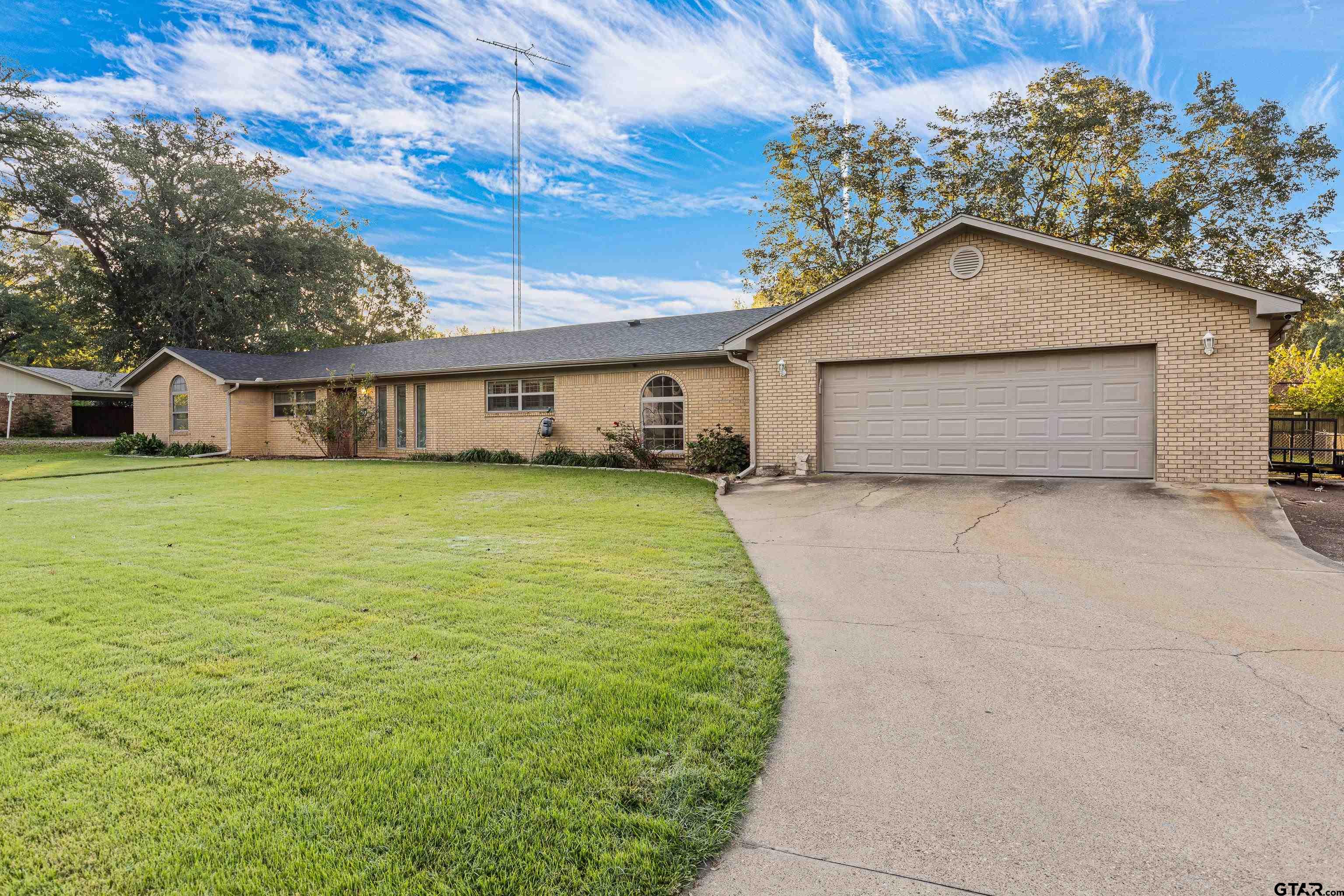 a view of a house with a yard and garage