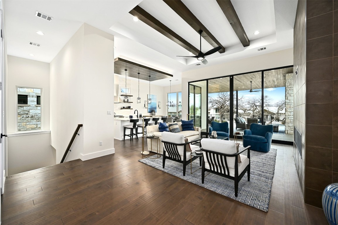 a living room with furniture and a floor to ceiling window