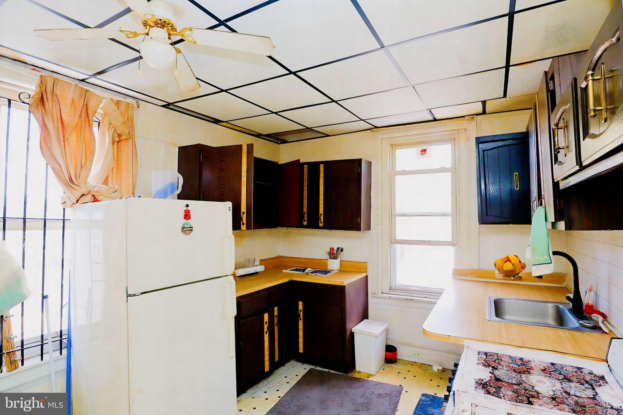 a refrigerator freezer sitting inside of a kitchen