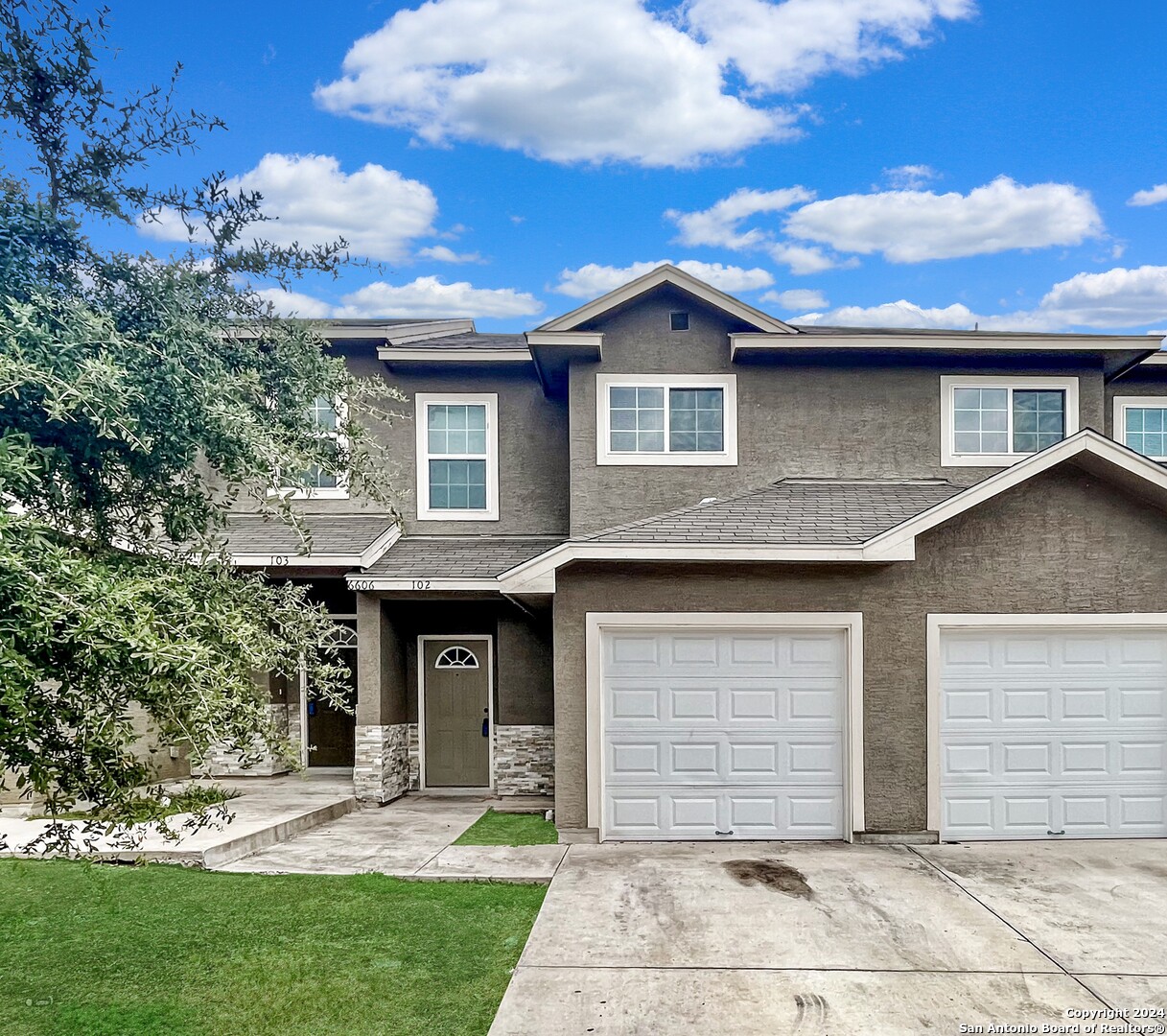 a front view of a house with a yard