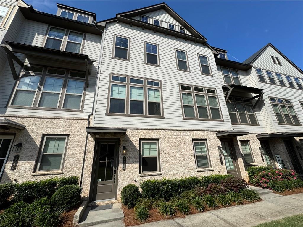 a front view of a residential apartment building with a yard