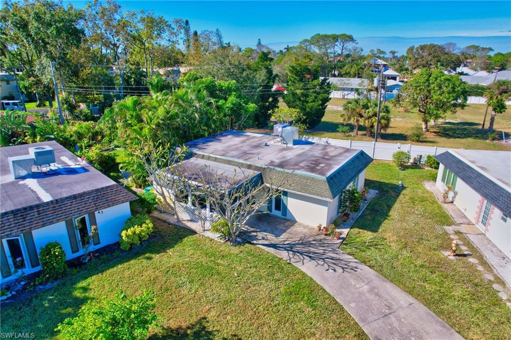 an aerial view of a house with a garden and lake view