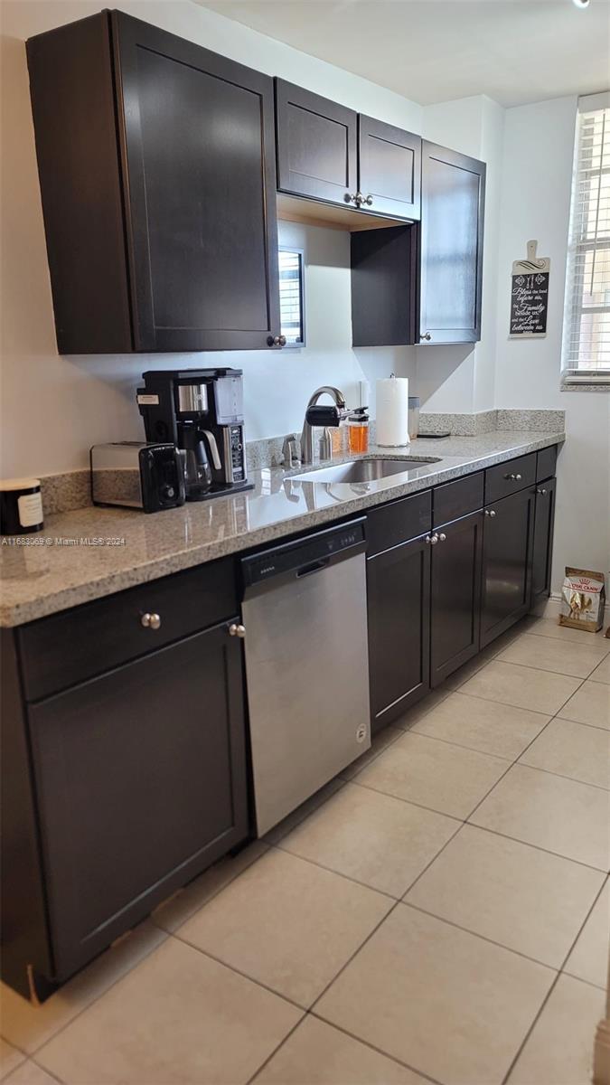 a kitchen with stainless steel appliances granite countertop a sink and a stove