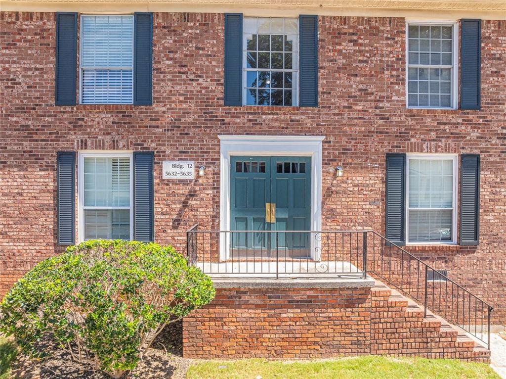 a view of a brick building next to a yard