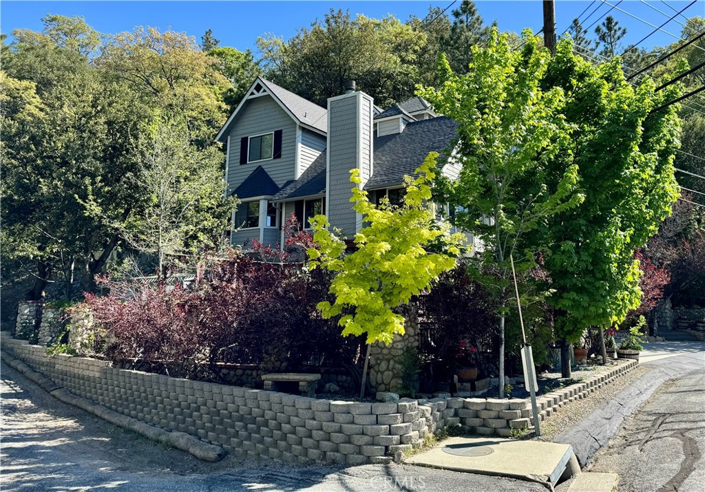 a view of a house with a yard and tree s