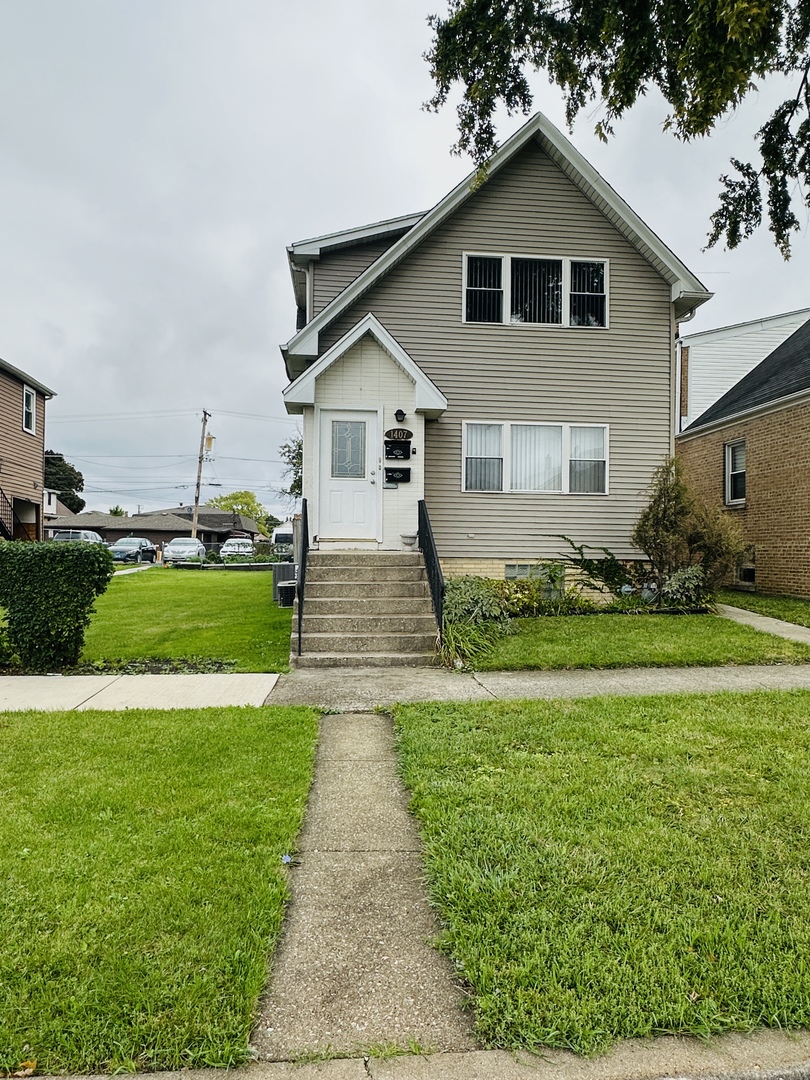 a front view of house with yard and green space