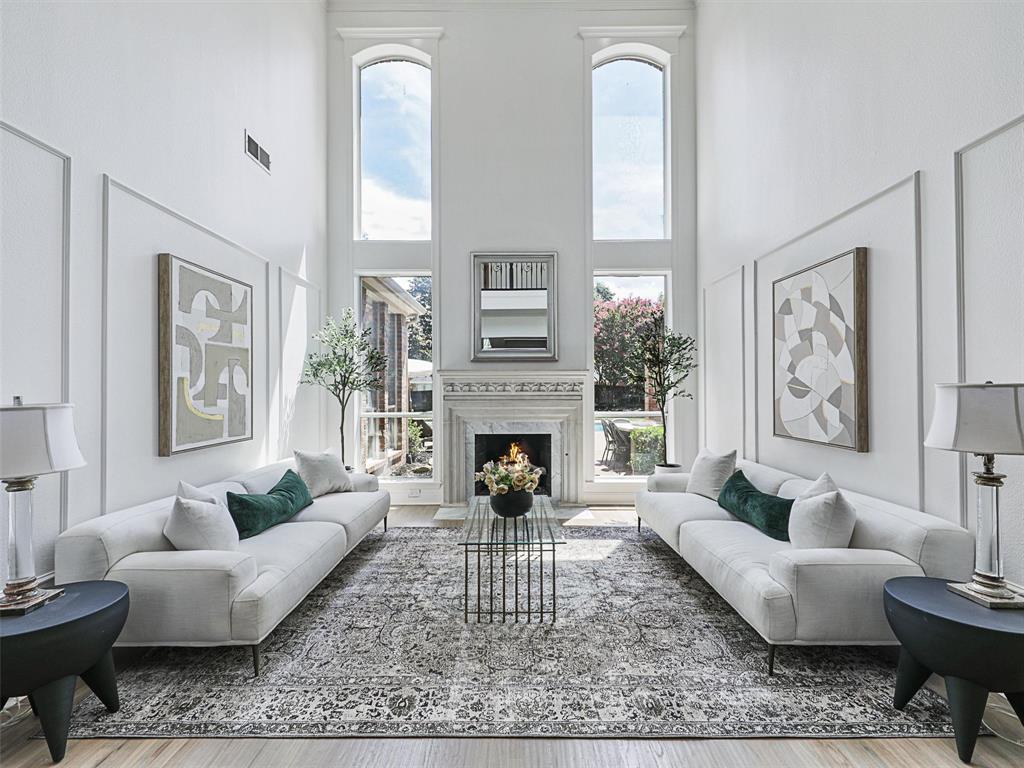 a living room with furniture a fireplace and a large mirror