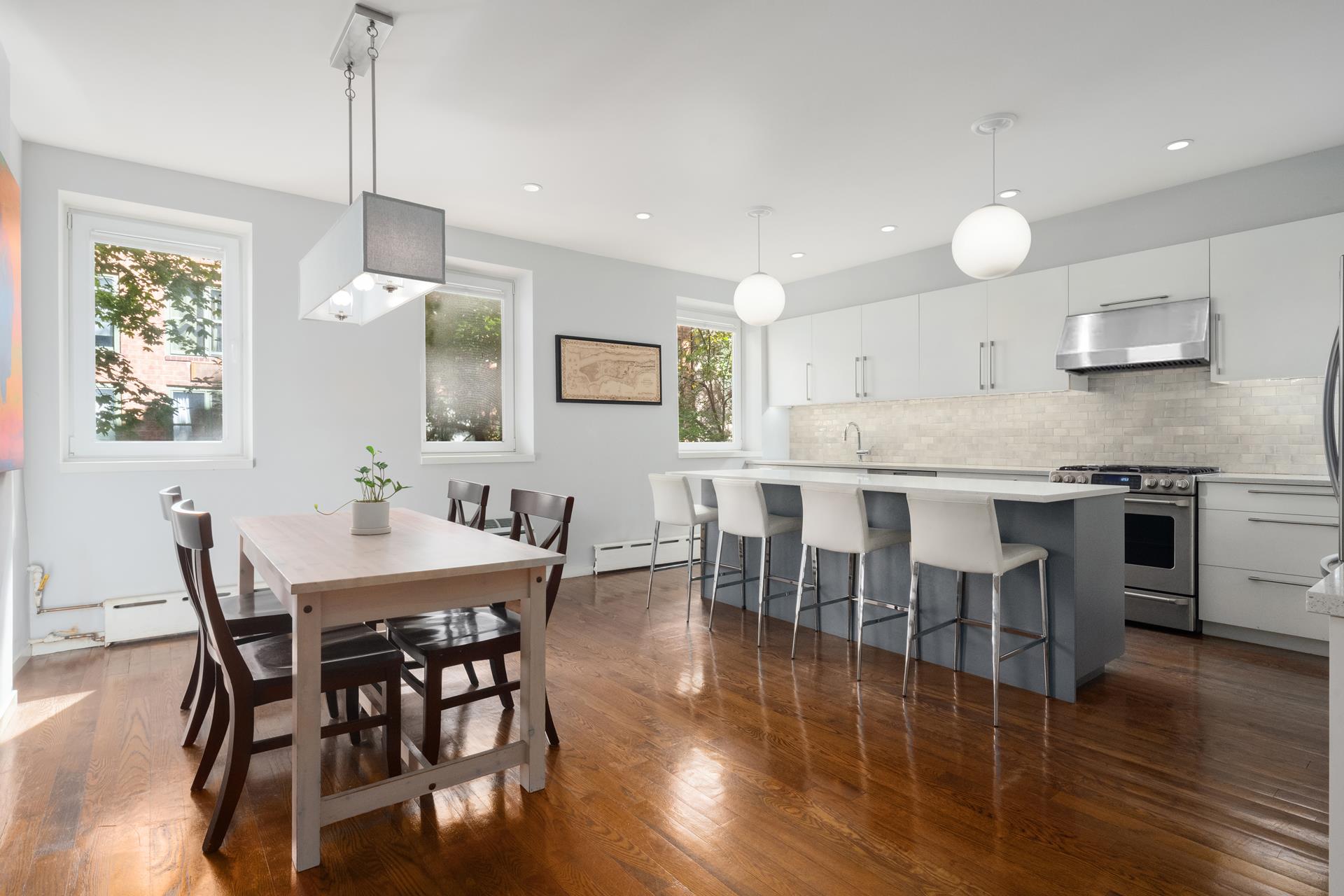 a large kitchen with a table and chairs