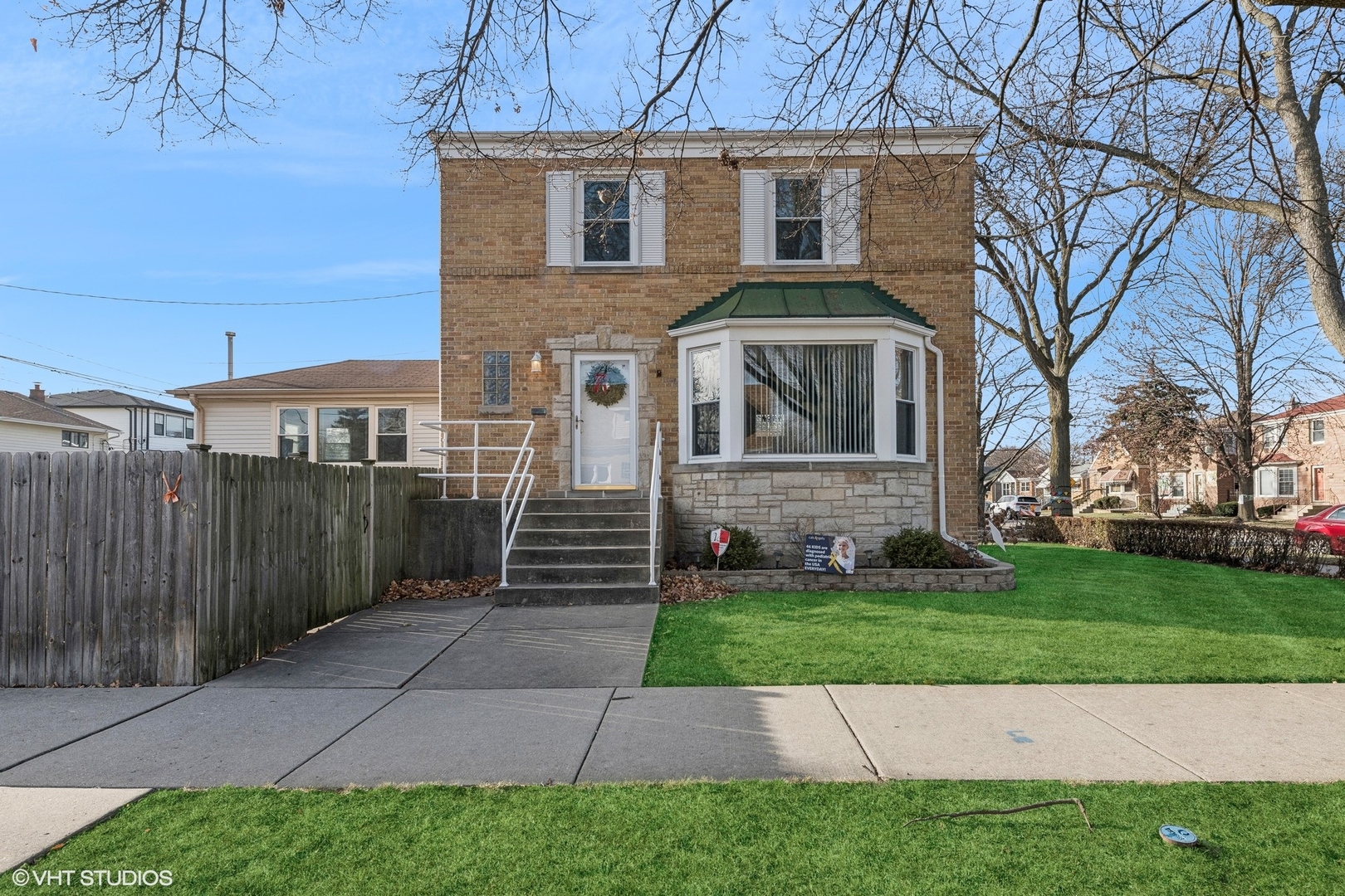 a front view of a house with a garden