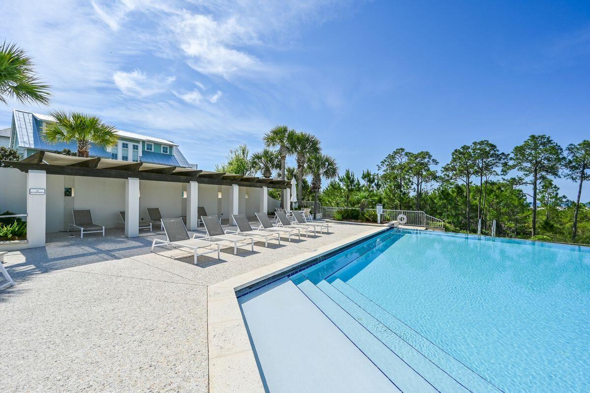 a view of a house with pool and sitting area