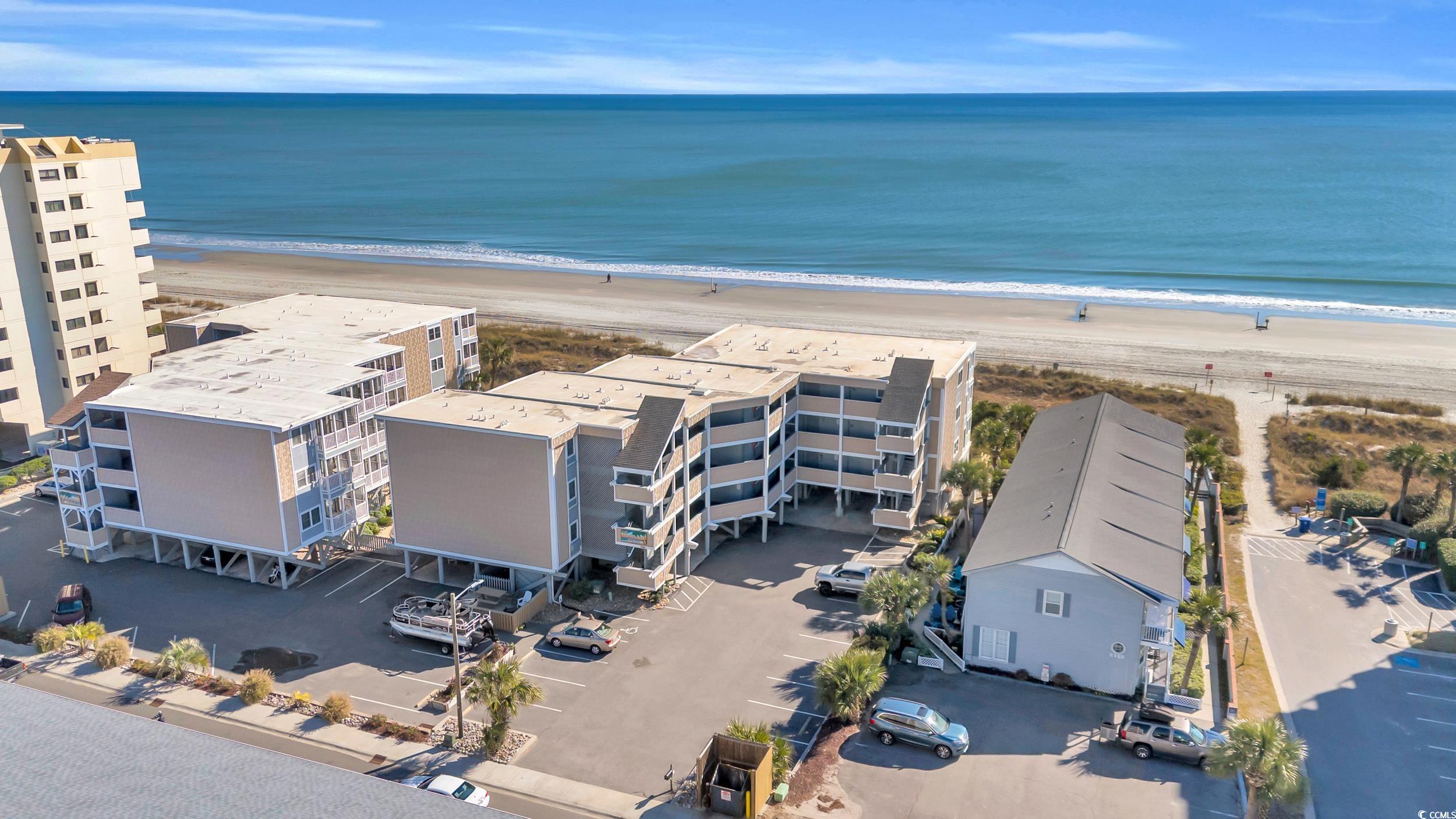 Aerial view featuring a water view and a beach vie