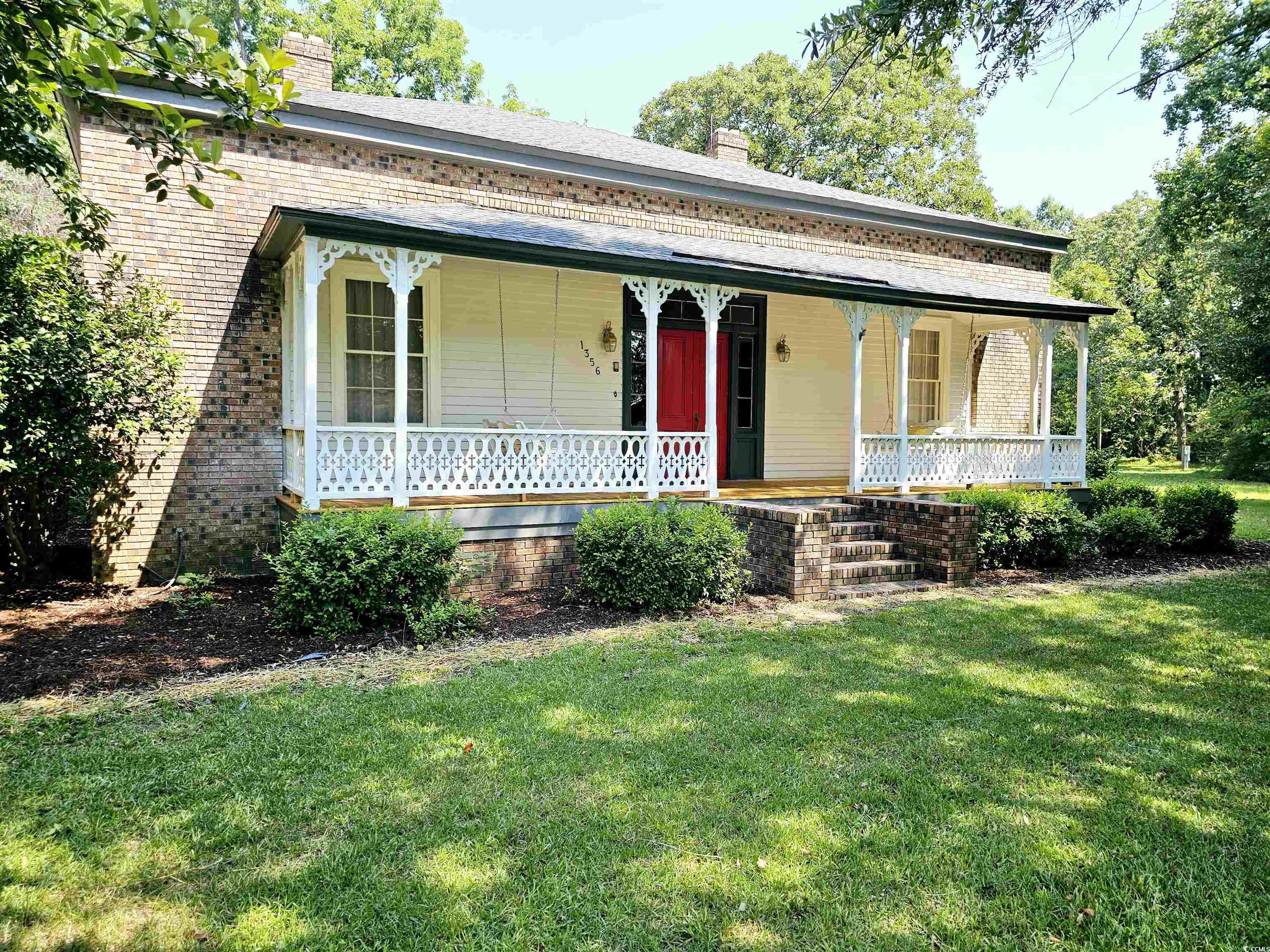 View of front of home featuring a front yard and c