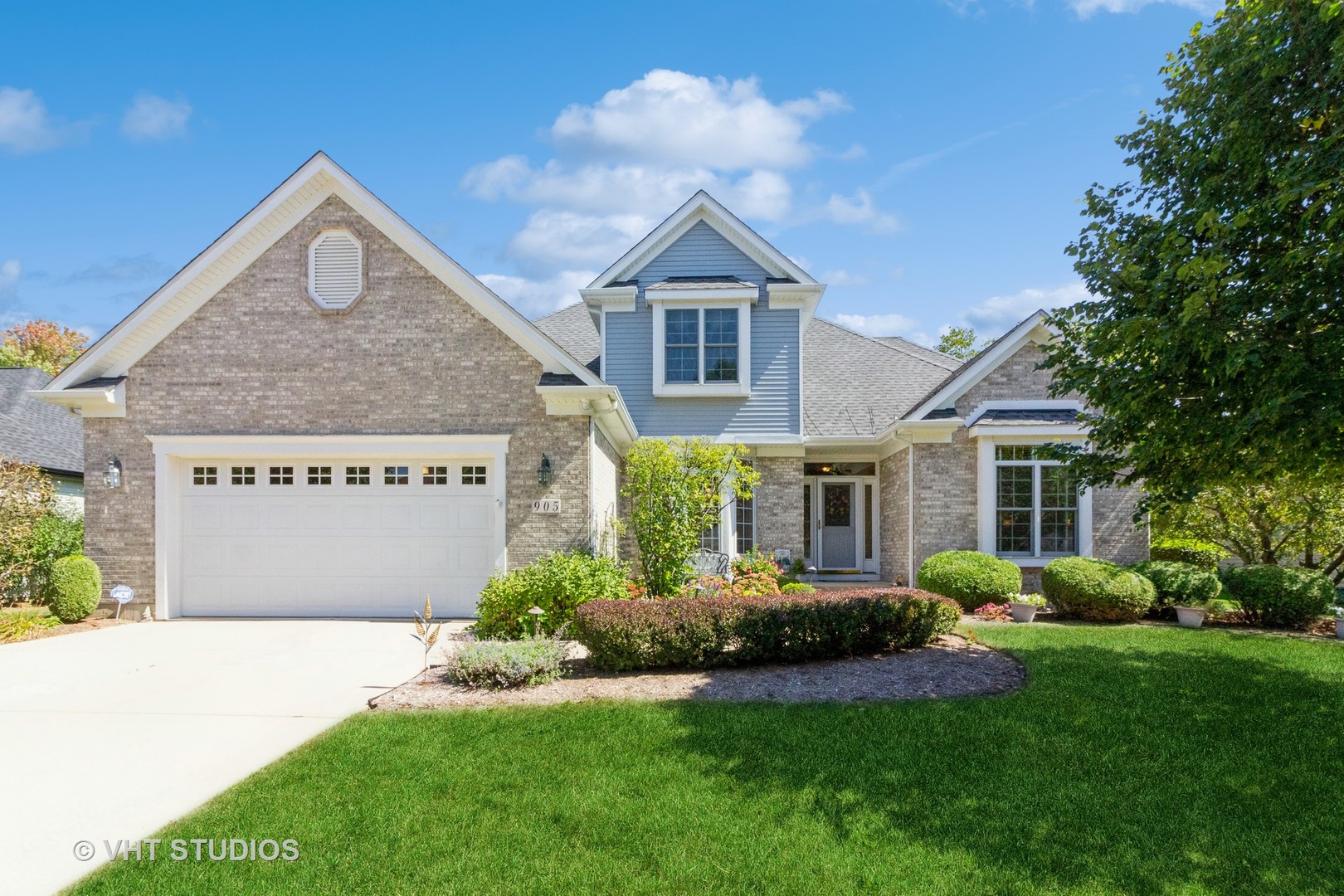 a front view of a house with a yard and garage