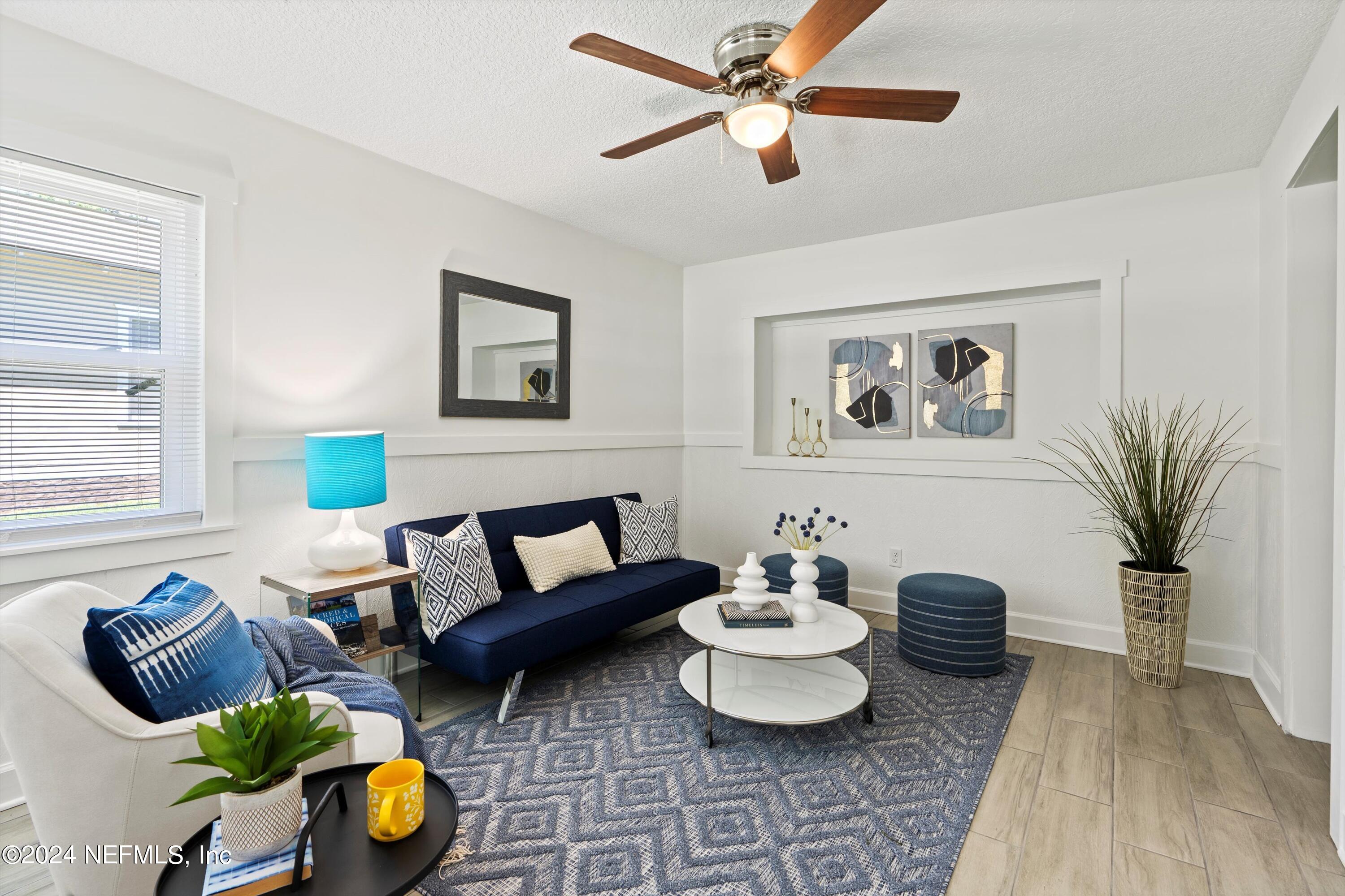 a living room with furniture and a wooden floor