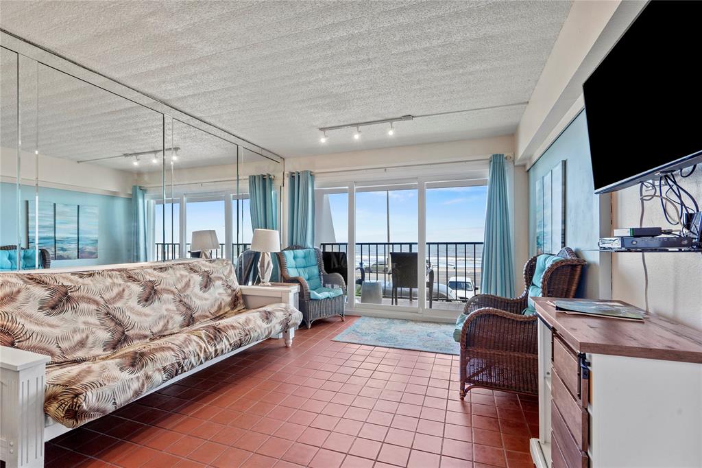 a living room with furniture large window and flat screen tv