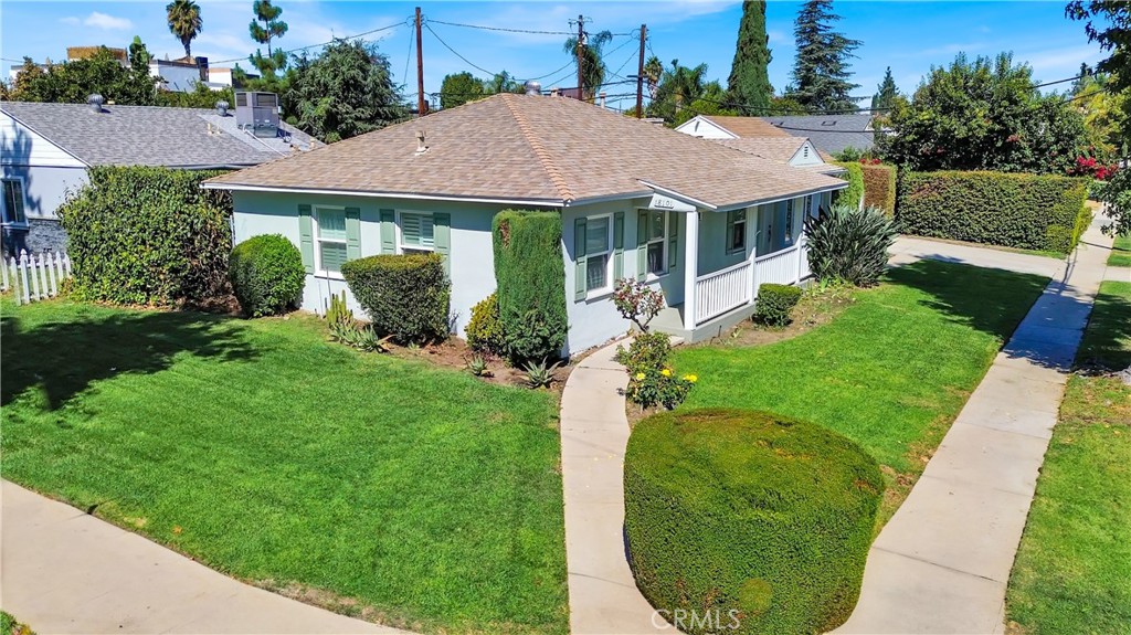 a aerial view of a house with swimming pool garden and patio