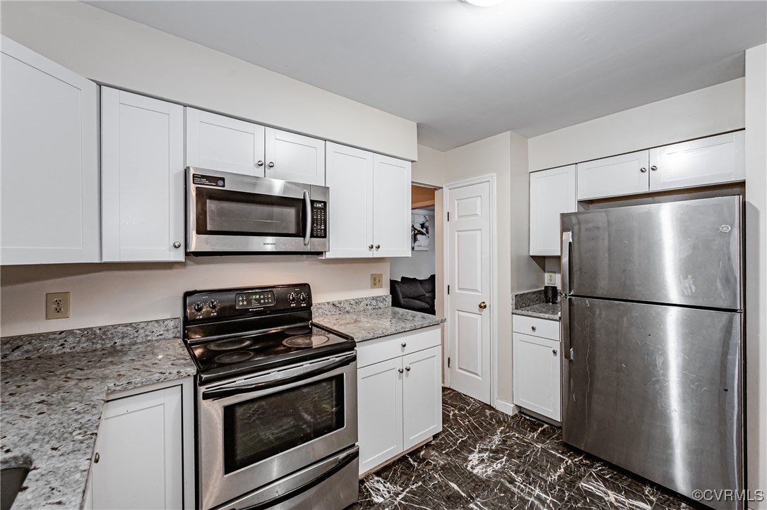 Kitchen featuring stainless steel appliances, whit