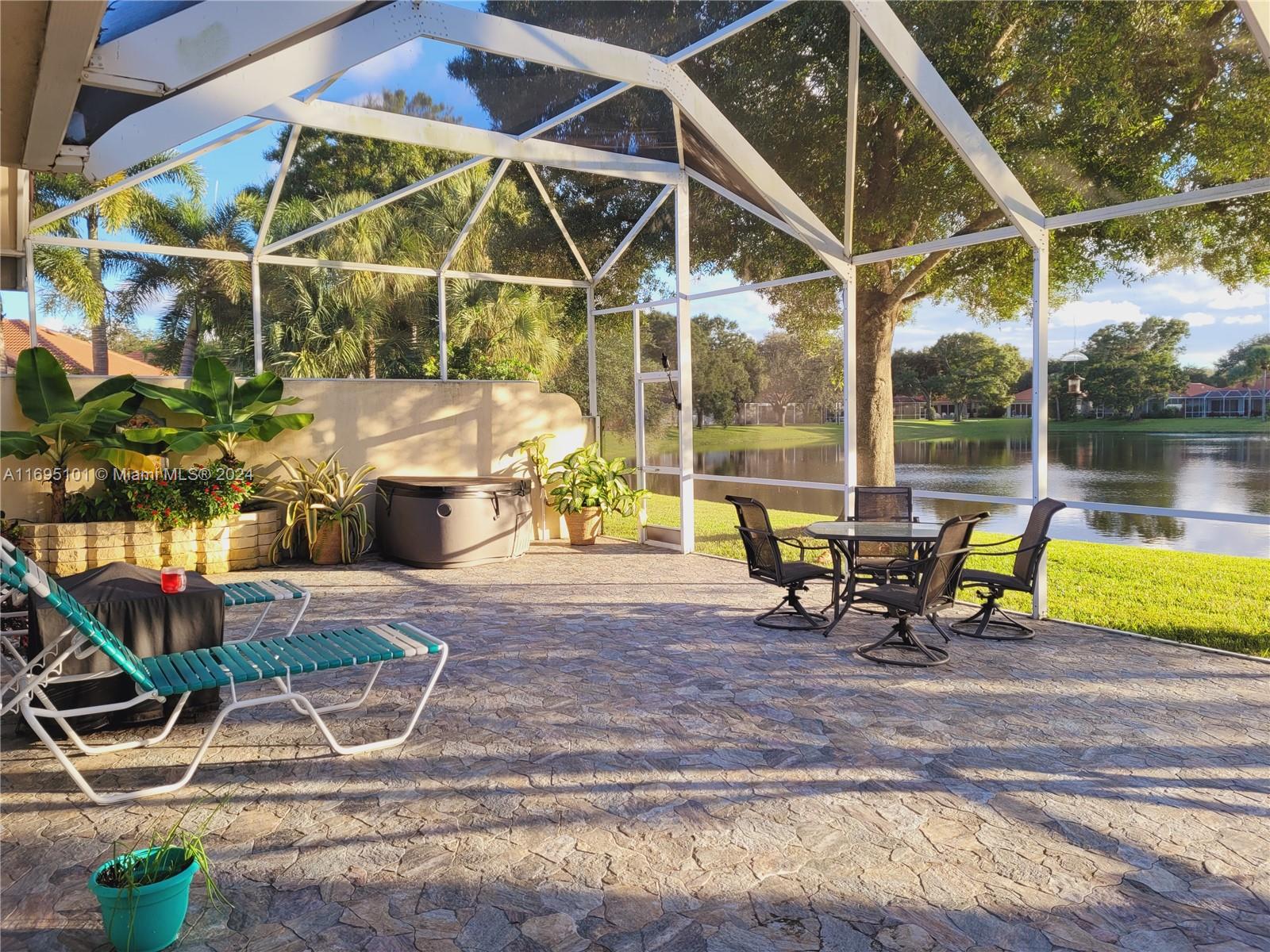 a view of a house with backyard and sitting area