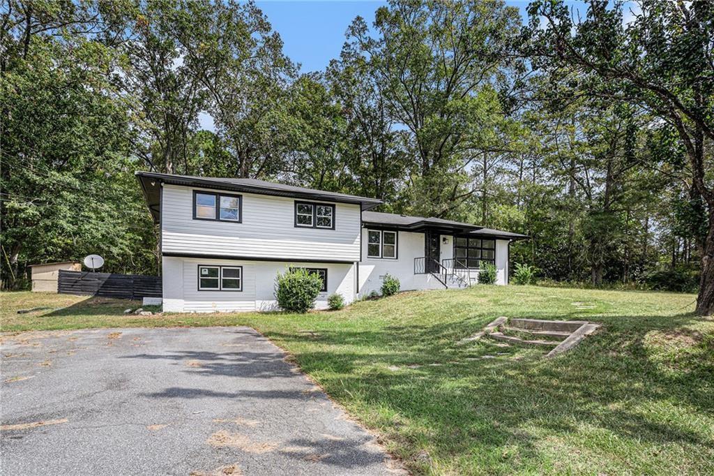 a house that has a big yard with large trees