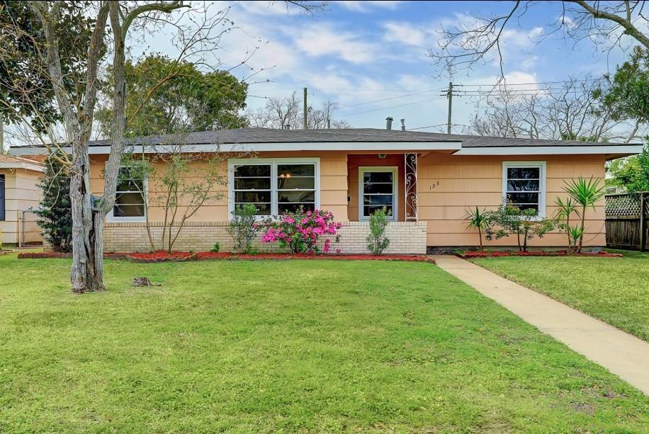 a front view of house with yard and outdoor seating