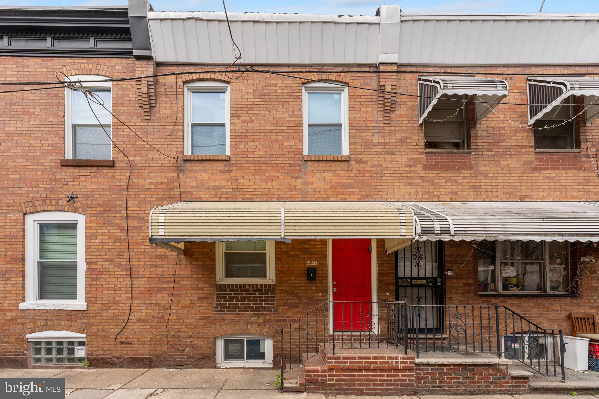 a view of a brick house with many windows