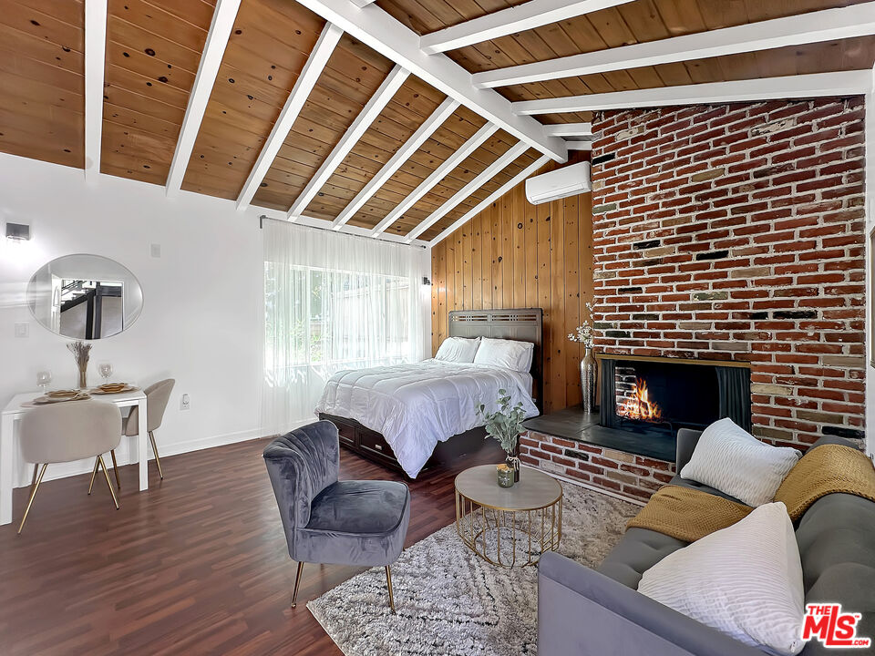 a bedroom with furniture and a fireplace