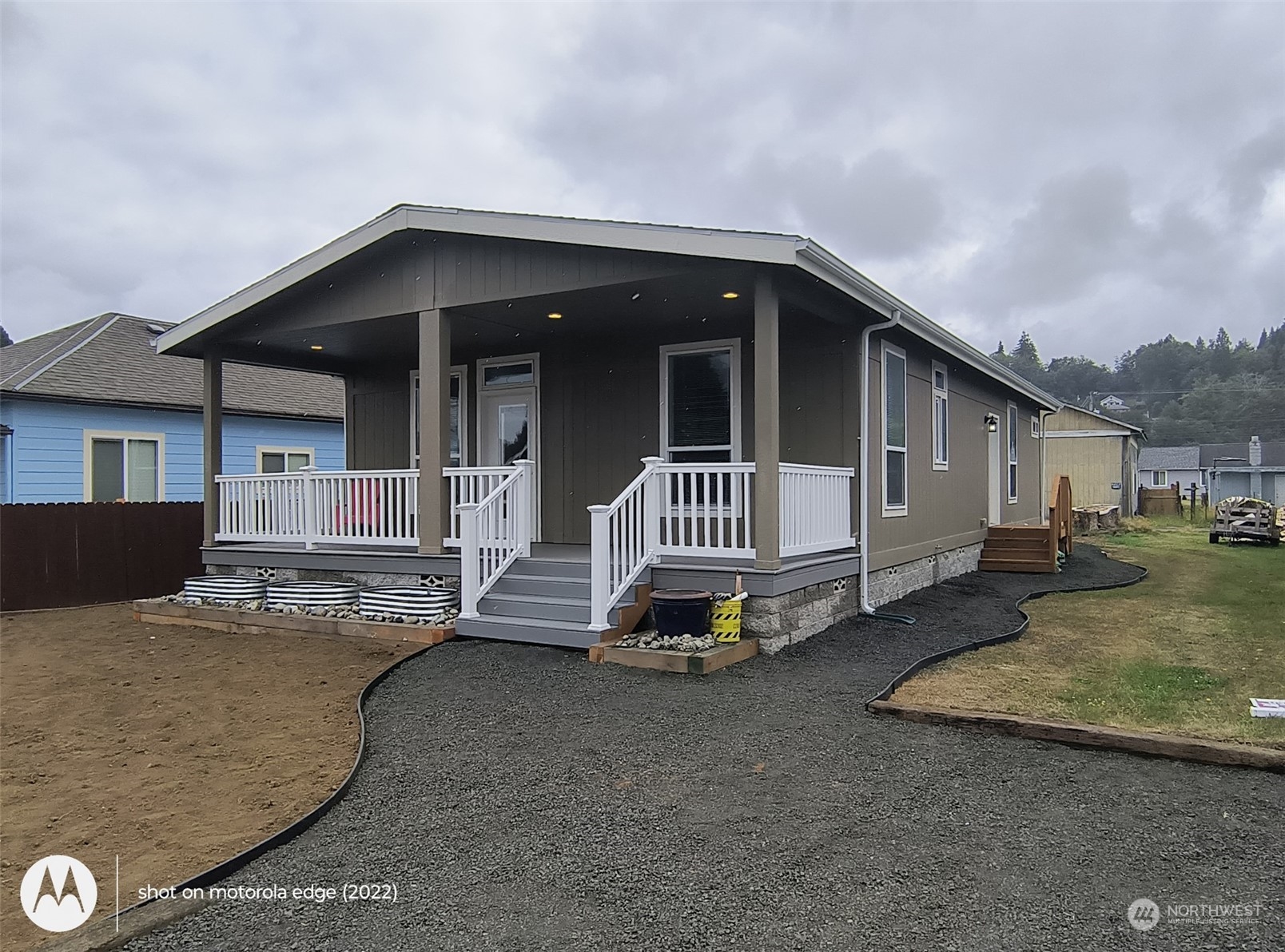 a view of a house with a patio and a yard