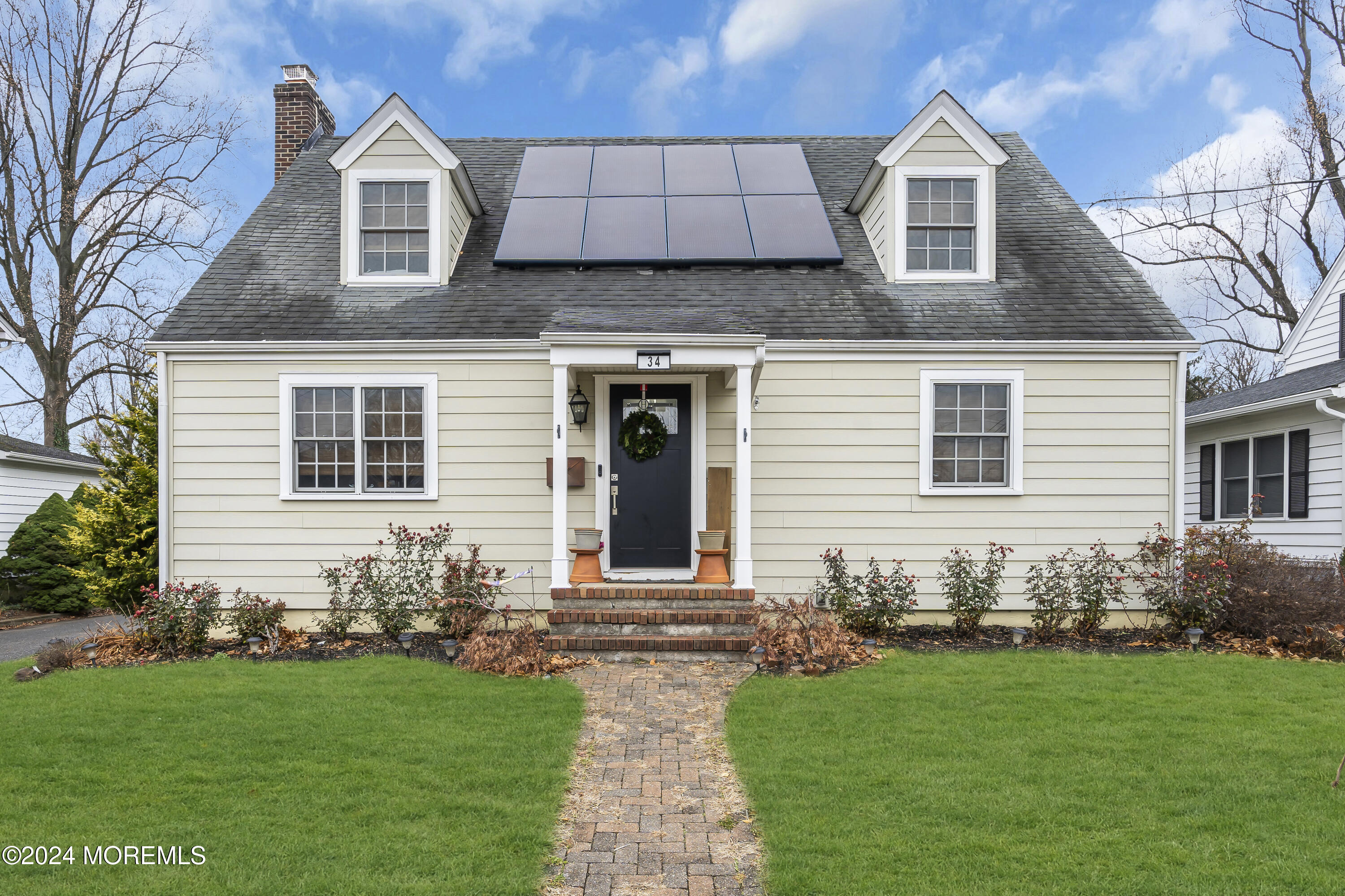 a front view of a house with a garden