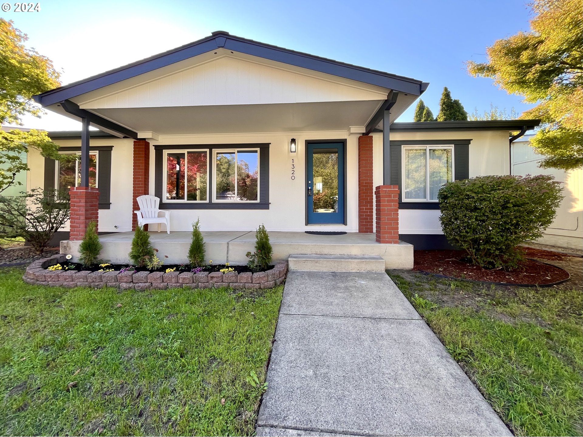 a front view of a house with a yard and porch