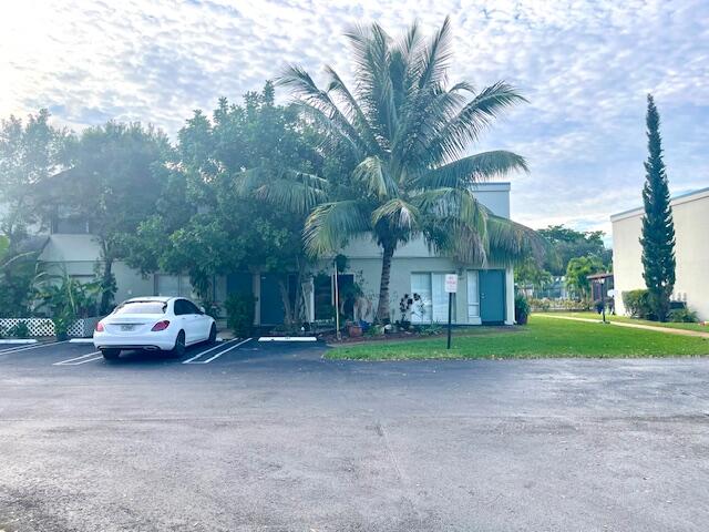 a couple of cars parked in front of a house