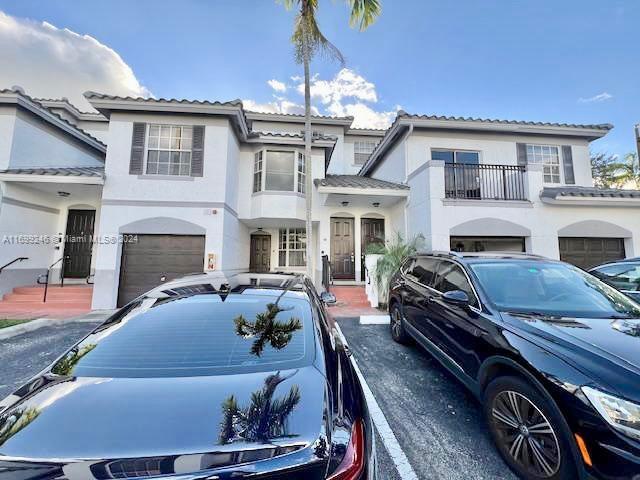 a view of a house with car parked