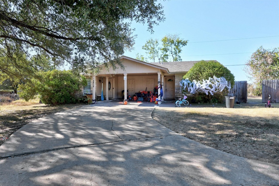 a view of a house with a yard and palm trees