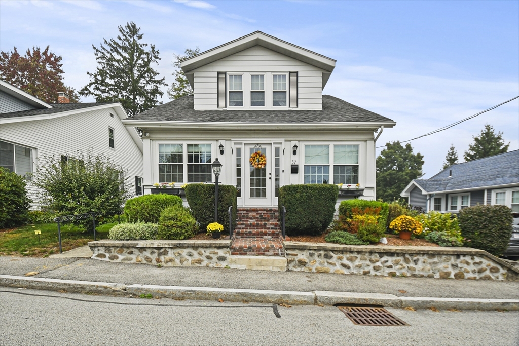 a front view of a house with garden