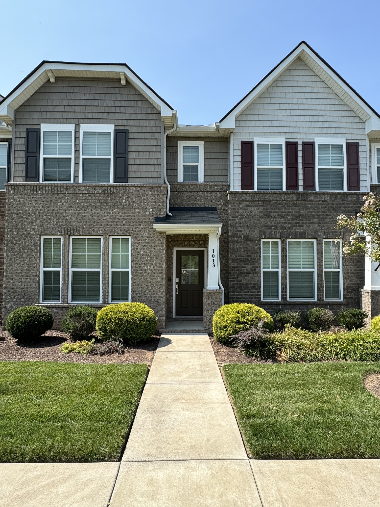 a front view of a house with garden