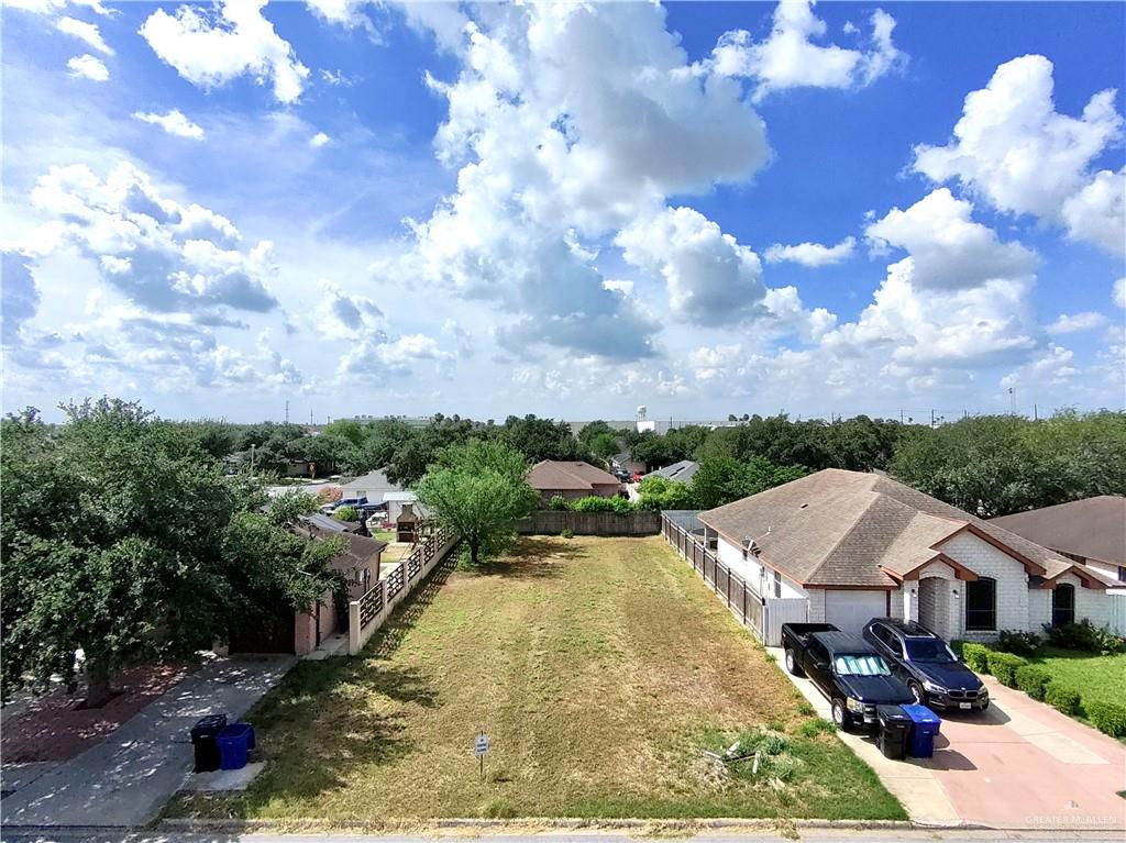 an aerial view of residential houses with yard