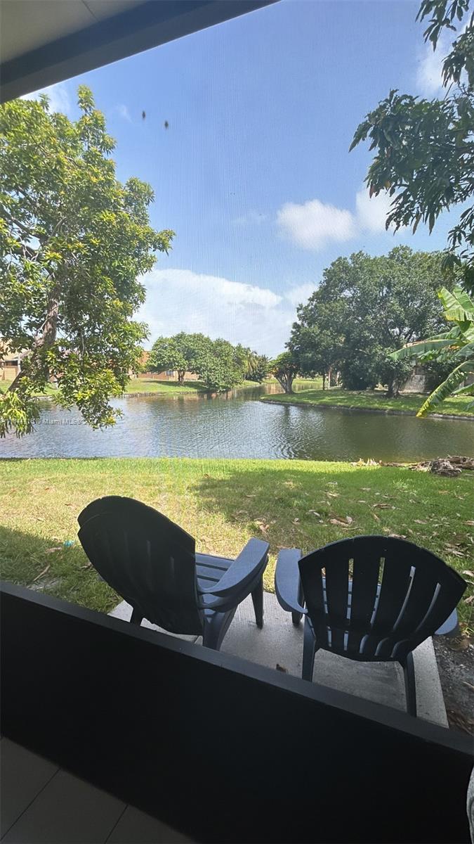 a view of a lake with a table and chairs