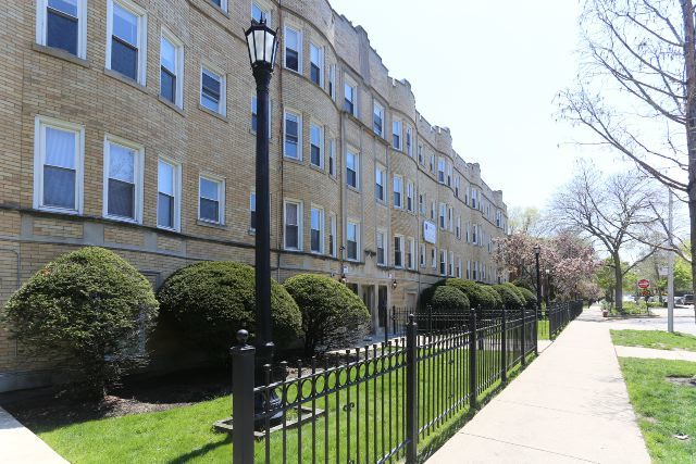 a view of a building with a yard