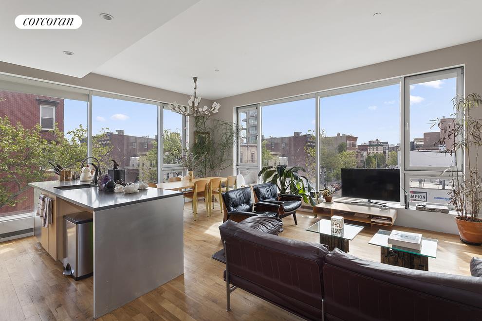 a view of a workspace with furniture and floor to ceiling window