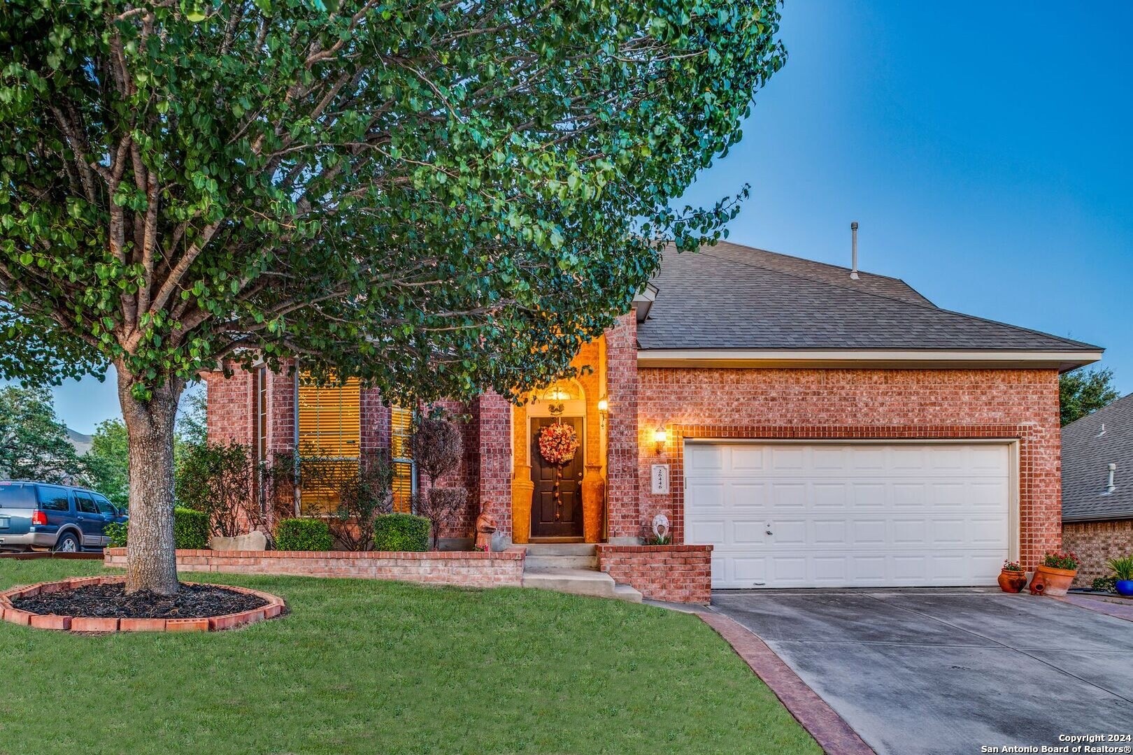 a front view of a house with a yard and garage