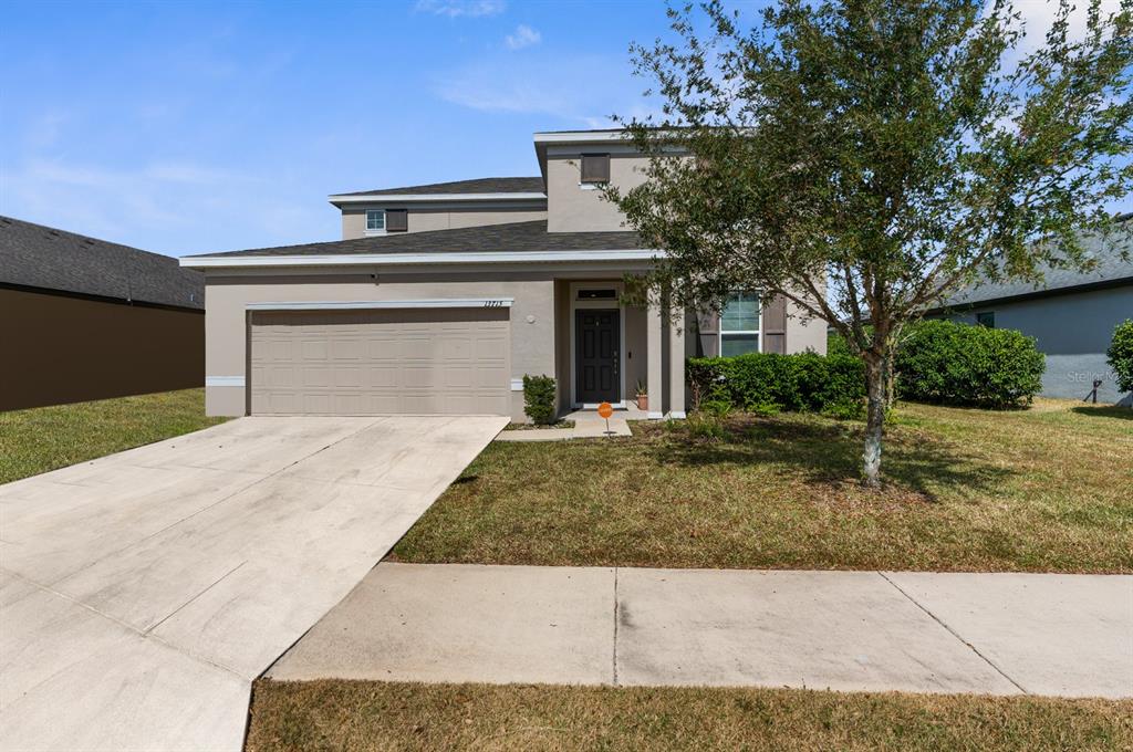 a front view of a house with garage