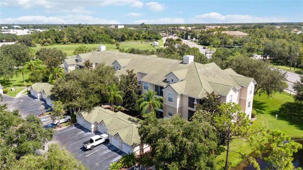 an aerial view of a house with a yard and lake view