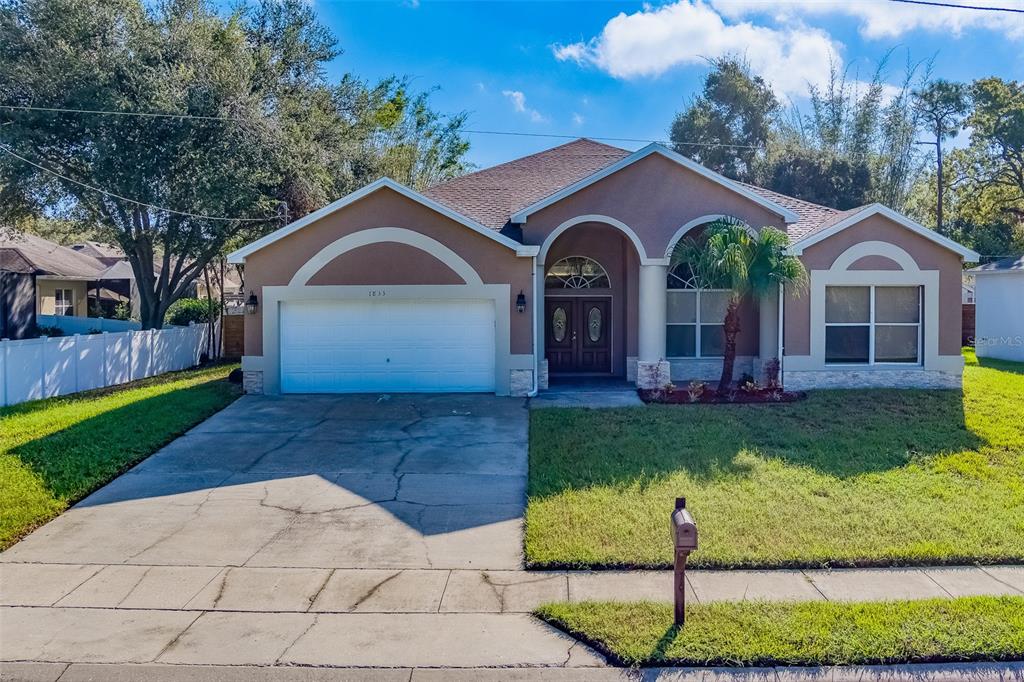 a front view of a house with a yard and garage