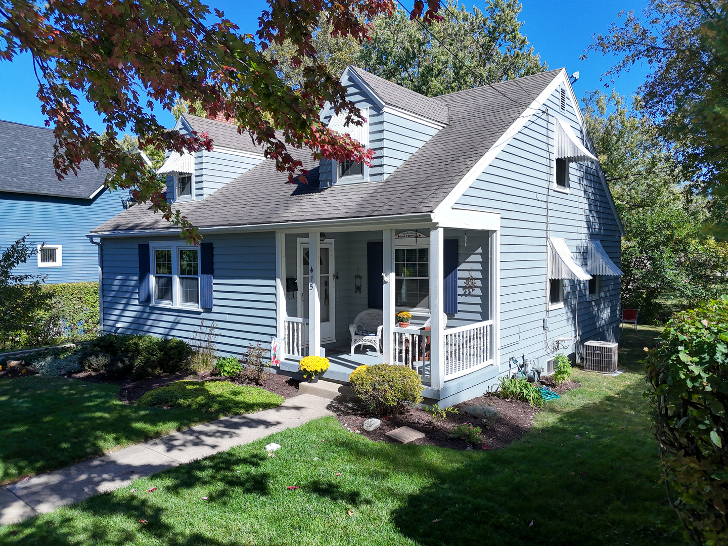 a front view of a house with a garden and plants