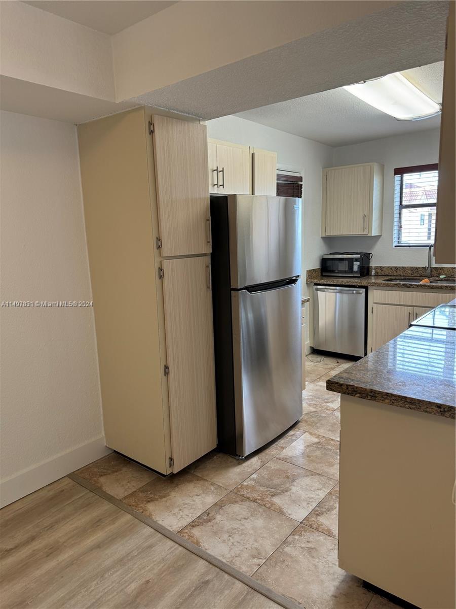 a kitchen with a refrigerator sink and stove