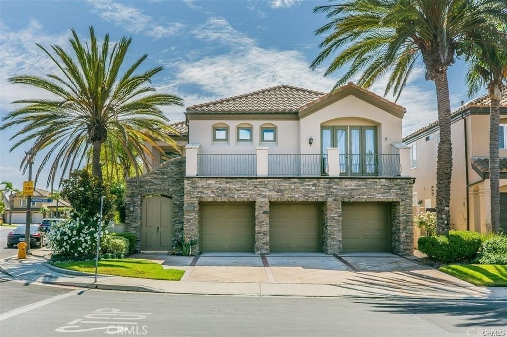 a front view of a house with a garden and a garage