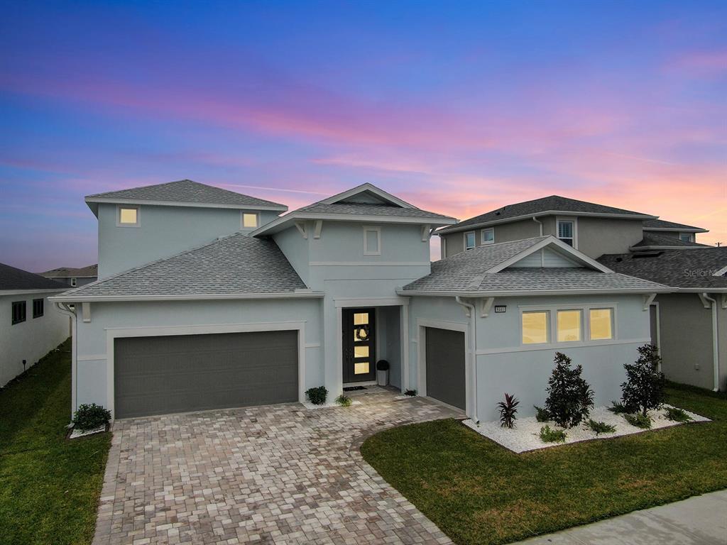 a front view of a house with a yard and garage