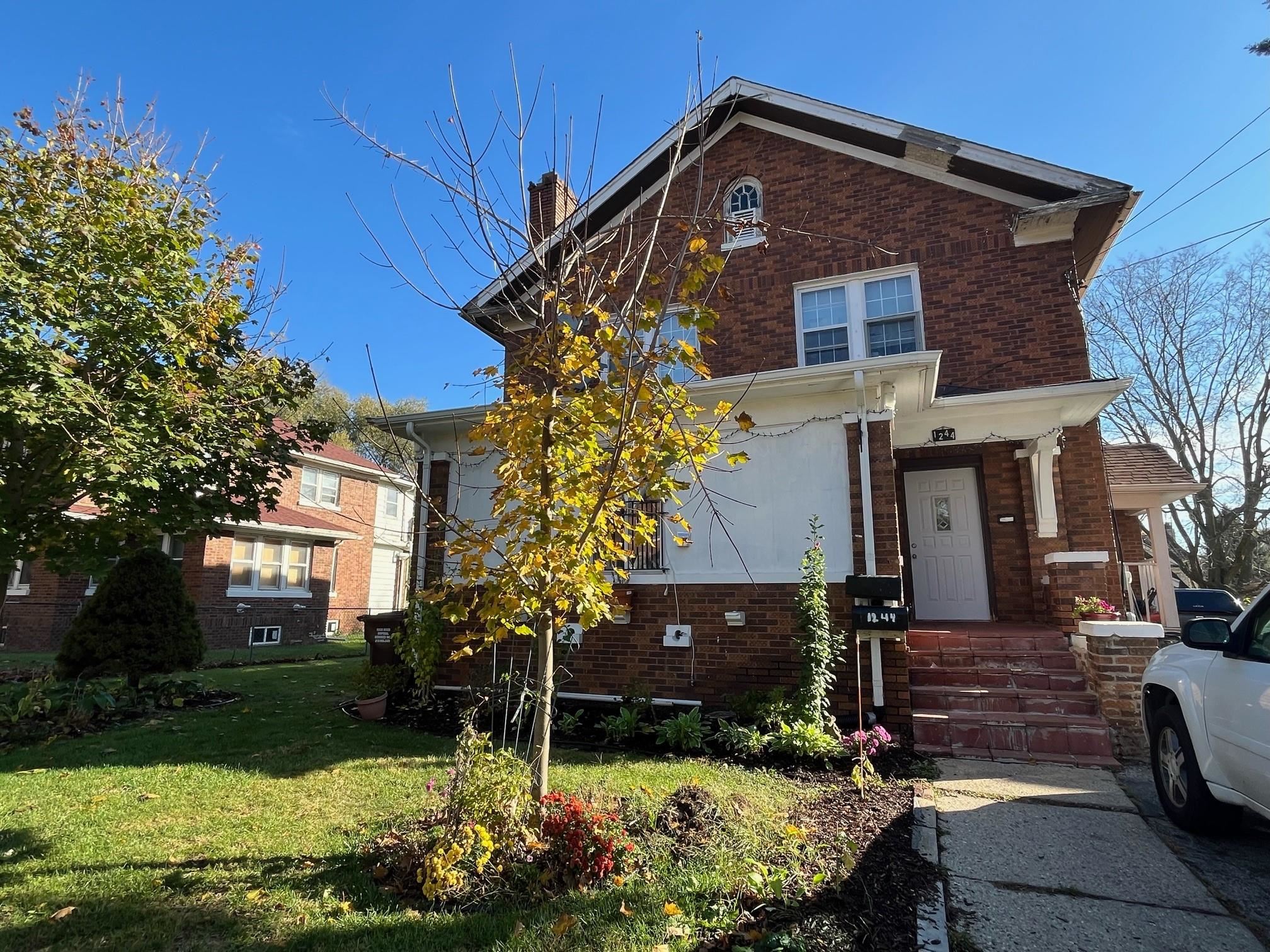 a front view of a house with garden